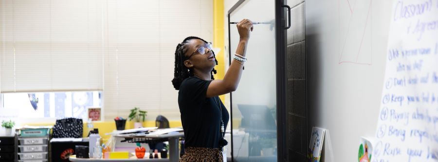 Teacher writing on the board